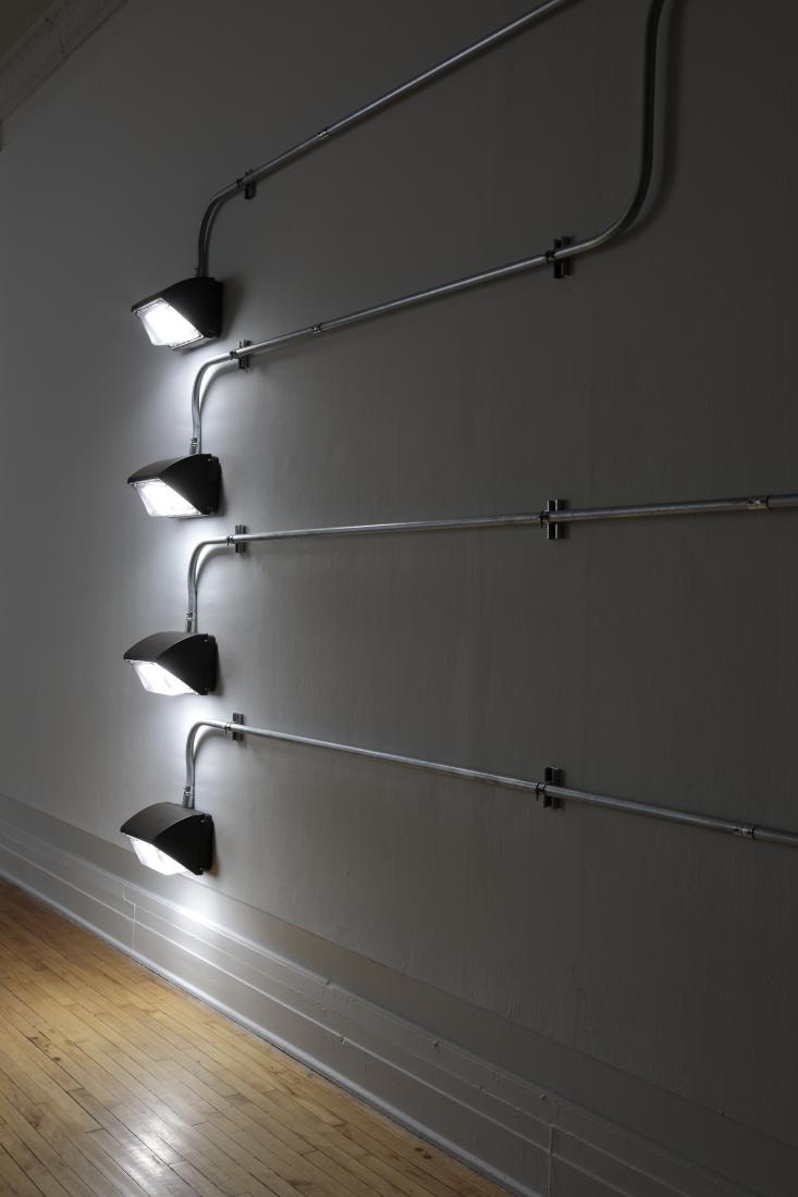 Western Standards K80X4, 2019. Dimension variable. Electrical conduit connected to building's power supply, 4 LED lamps, existing architecture