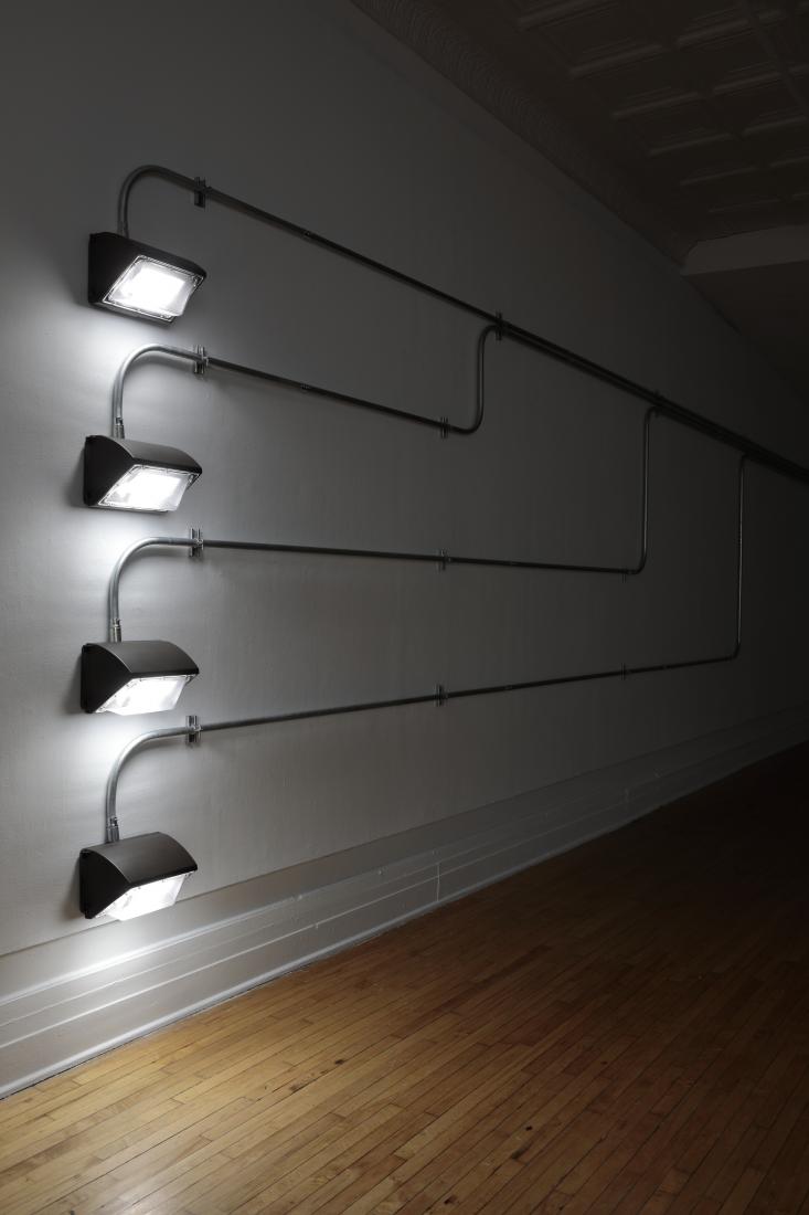 Western Standards K80X4, 2019. Dimension variable. Electrical conduit connected to building's power supply, 4 LED lamps, existing architecture