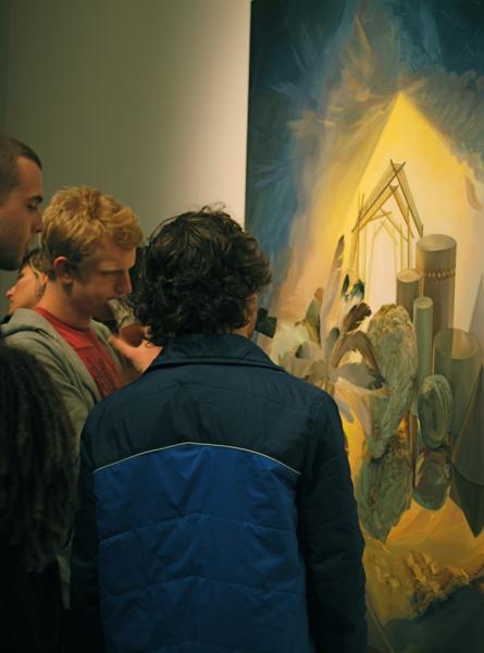 Gallery visitors admiring a painting by Christine Gray