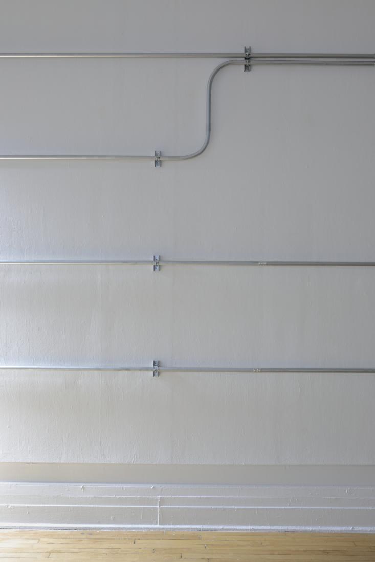 Western Standards K80X4, 2019. Dimension variable. Electrical conduit connected to building's power supply, 4 LED lamps, existing architecture